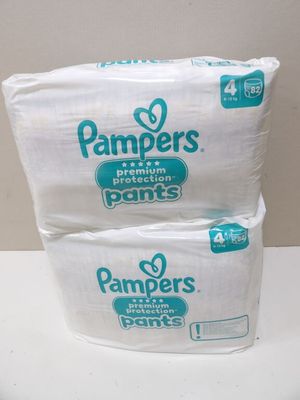 two packs of pampers diapers sitting on top of each other