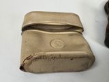 tan leather purse with zipper on top of it on a white surface