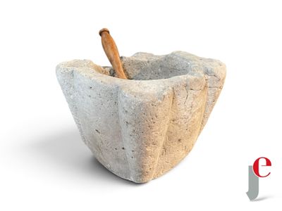 a stone mortar with a wooden stick in it