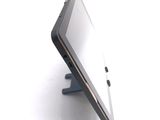a tablet computer sitting on a stand on a white surface