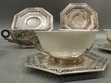three cups and saucers sitting on a table