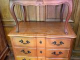 a dresser with a mirror on top of it in a room