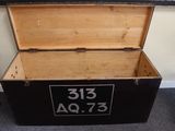 a wooden box with numbers on it sitting on the floor