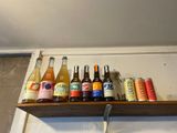a shelf that has many different types of drinks on it