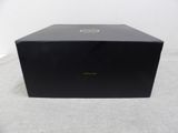 a black box sitting on top of a white table next to a white wall