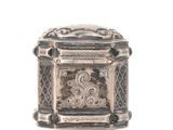 a small silver box that is sitting on a white surface