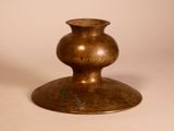 a bronze vase that is sitting on a table
