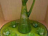 a green glass pitcher and cups on a green tray