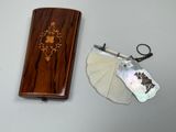 a small wooden box with a keychain and a tag on it