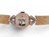 an image of a woman ' s watch with a gold band