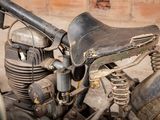 an old motorcycle that is sitting in the dirt