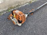 a close up of a chainsaw on the ground next to a wall