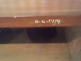 a close up of a wooden shelf with a clock on it