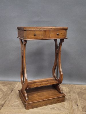 an old wooden table with a drawer on top of it on a wooden floor