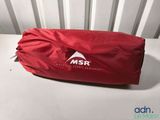 a red bag sitting on top of a white table