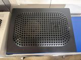 a black and silver speaker sitting on top of a blue table