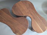 two pieces of wood sitting on a table next to each other