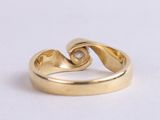 an image of a close up of a gold ring on a white surface