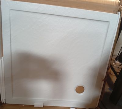 a white refrigerator sitting on top of a hard wood floor