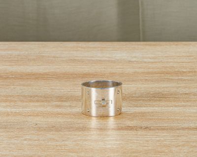 an image of a silver ring on a wooden table