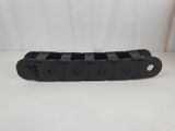 a close up of a black plastic chain on a white surface