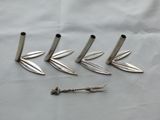 four silver metal knives and a screw on a white cloth