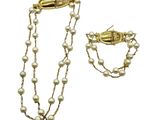 a close up of a necklace and bracelet with pearls on a white background