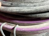 a person holding a purple hose in their hand