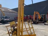 an image of a yellow crane in a parking lot