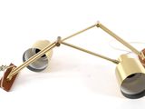 pair of brass and black lamps on a white background