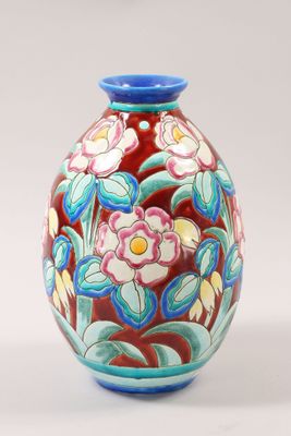 a vase with flowers painted on it sitting on a table