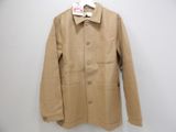 the jacket is hanging on a hanger on the wall
