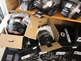 many boxes of helmets on the floor in a room
