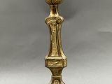 an antique brass table lamp with a glass shade on top of it