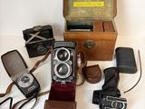 de nombreux modèles différents d'appareils photo anciens posés sur la table