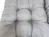 a grey chair cushion with a button on the back of it