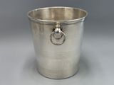 an antique silver plated ice bucket with a ring handle