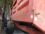 a red dump truck that is parked in a barn
