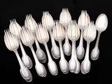 a lot of silver spoons and spoon spoons on a black background