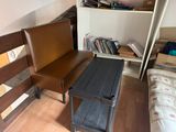 a small table and a chair in a small room