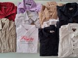 a lot of shirts that are sitting on a shelf