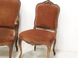 two chairs sitting next to each other on a white floor