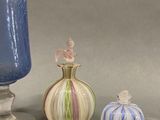 three vases and a small vase on a table