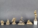 several figurines of different sizes and shapes on a black surface