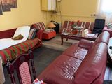 a living room with a couch, chair, table, and television