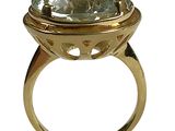 an image of a gold ring with a green topazt stone