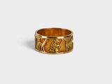 a close up of a gold ring on a white surface