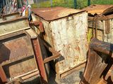 a pile of junk sitting on the ground next to a fence