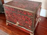 a red and black box sitting on top of a wooden table