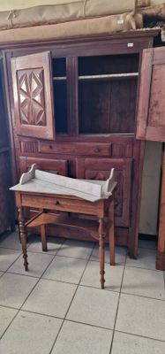a wooden cabinet and a small table in a room